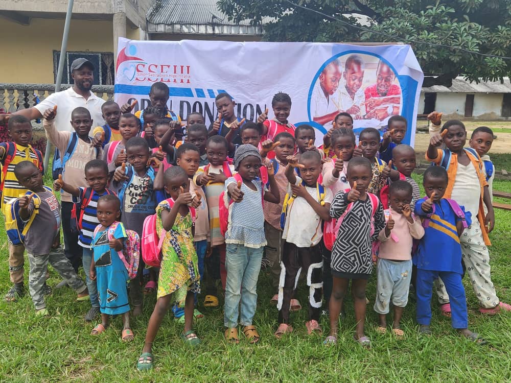 Children with donated school bags at an SSEHI open donation outreach