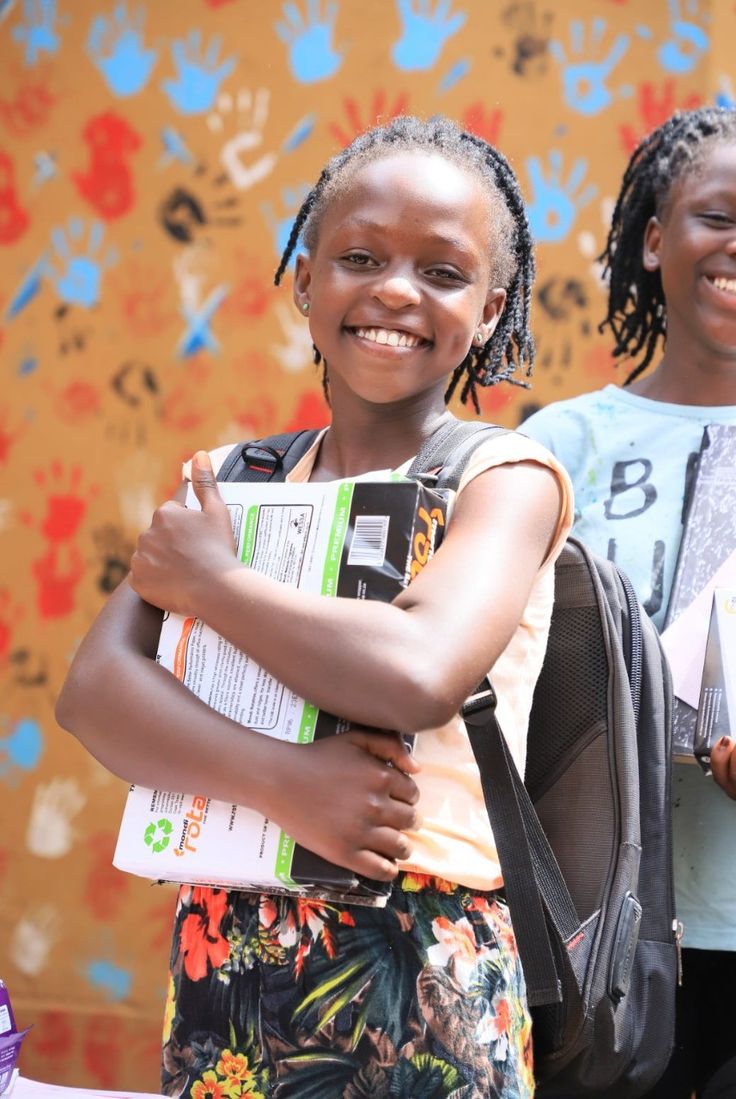 Smiling schoolgirl holding her books